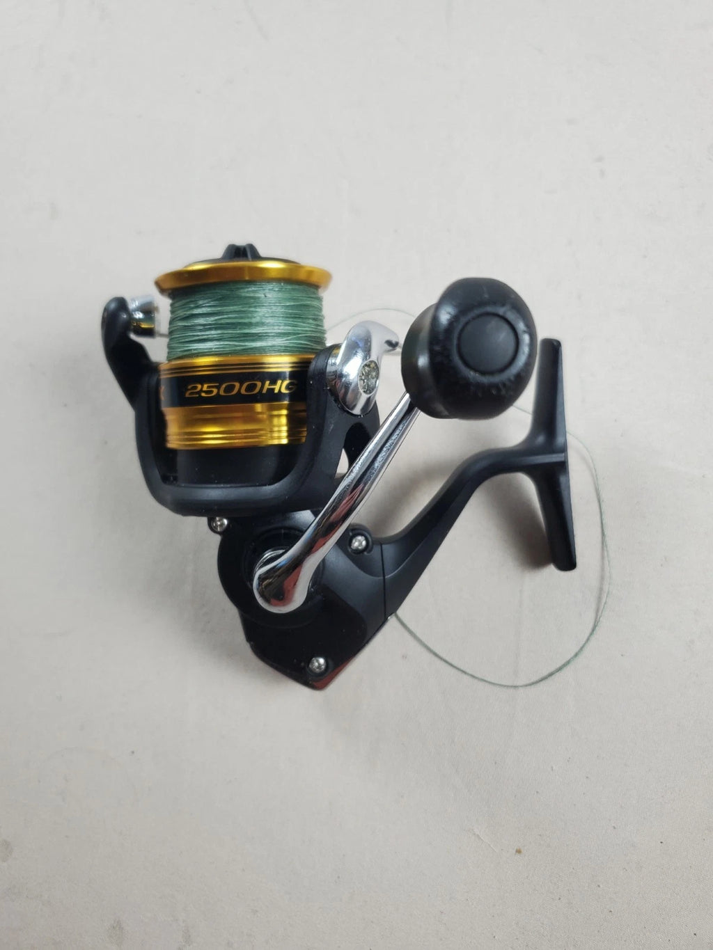 SHIMANO 2500HG Reel spun with heavy braided line. Appears unused.